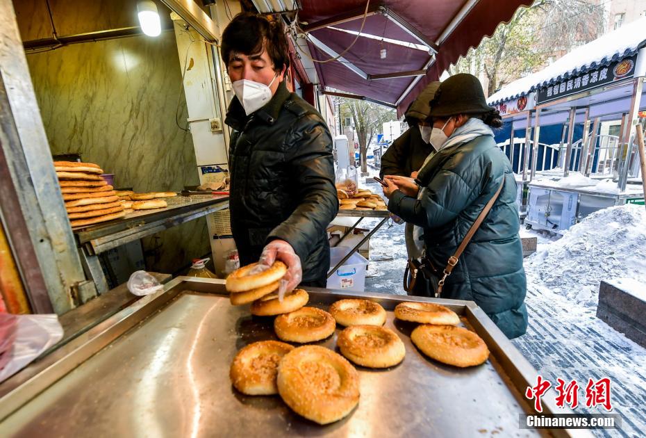 烏魯木齊市文化路，已開門營業(yè)的馕店吸引過往市民前來購買。 劉新 攝